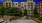 a building with trees and bushes in front of it