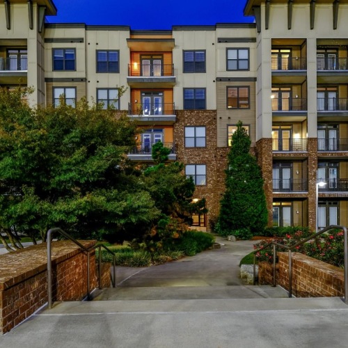 a building with trees and bushes in front of it