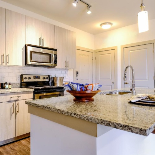 a kitchen with a marble island