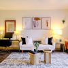 living room with a couch, chairs, and large plant
